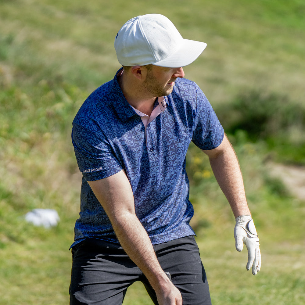 Male setting up to hit a golf shot in the Ripple Effect Polo by High Cut Golf NZ