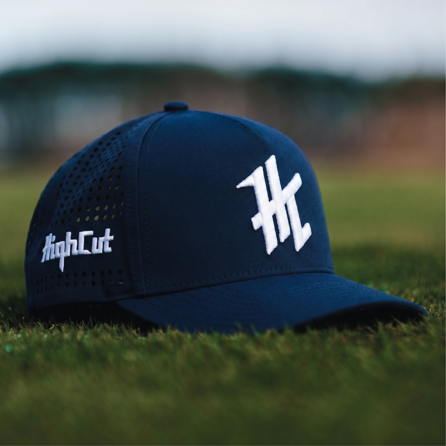 Navy golf cap with white embroidery by HighCut Golf NZ.