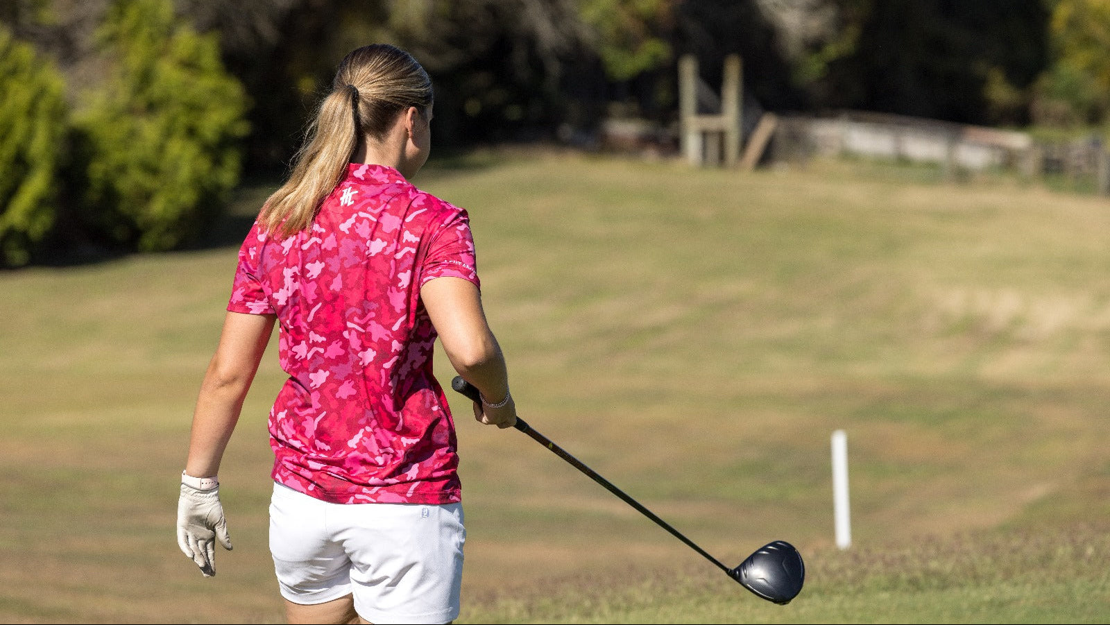 Girl wearing a pink pattern golf polo shirt
